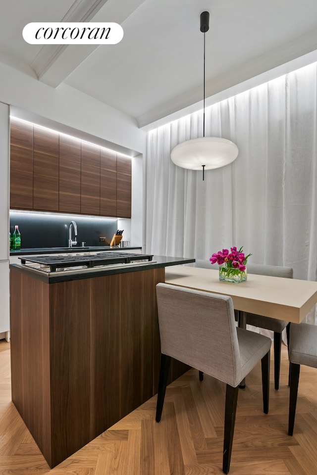kitchen featuring dark countertops, a sink, and modern cabinets