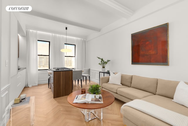 living room with a decorative wall, a wainscoted wall, ornamental molding, beam ceiling, and visible vents