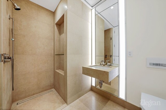 bathroom with a tile shower