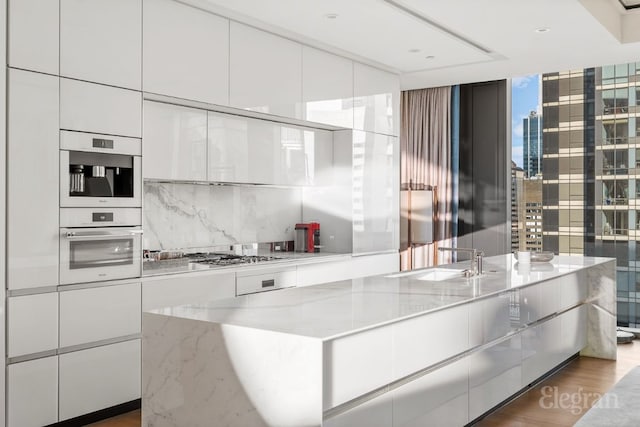 kitchen with light stone countertops and white cabinets