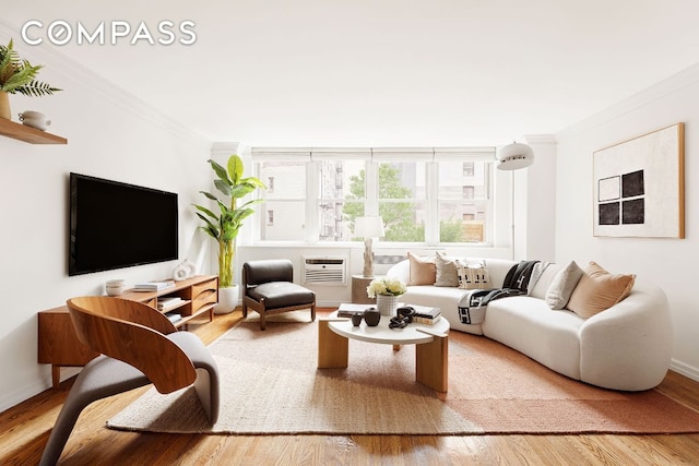 living room with crown molding and hardwood / wood-style flooring