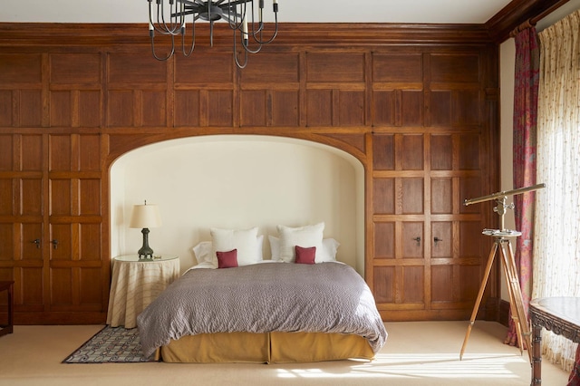bedroom with carpet floors, arched walkways, and a notable chandelier
