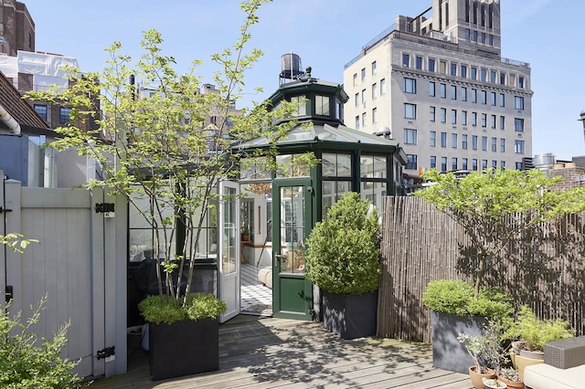 exterior space featuring fence and a deck