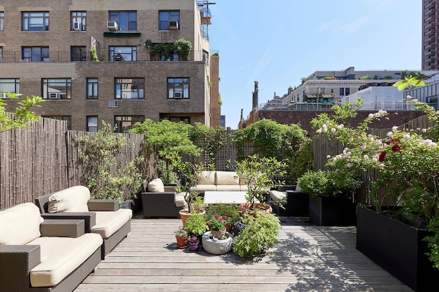 wooden terrace featuring fence and an outdoor hangout area