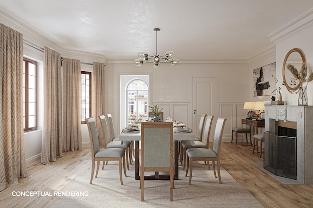 dining room with crown molding, a decorative wall, a high end fireplace, a chandelier, and light wood-type flooring