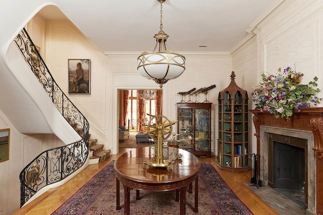 interior space featuring a high end fireplace, ornamental molding, and stairs
