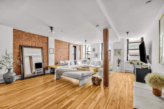 264 Water St Unit 5B, New York City, NY 10038 - bedroom featuring brick wall and light wood-style flooring