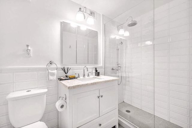 264 Water St Unit 5B, New York City, NY 10038 - full bath with tiled shower, vanity, toilet, wainscoting, and tile walls