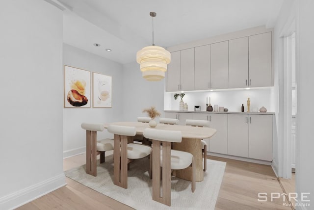 dining space featuring light wood-style flooring, baseboards, and recessed lighting