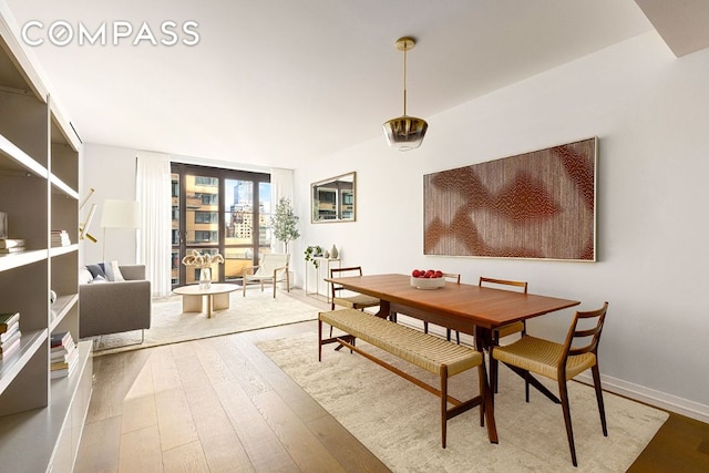 dining room with baseboards and wood finished floors