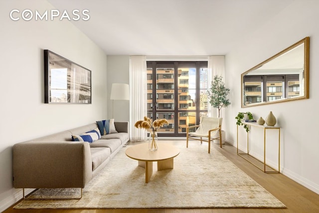 sitting room featuring light wood-type flooring and baseboards