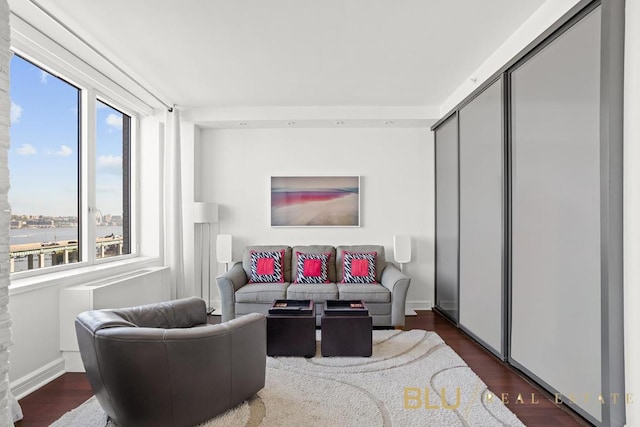 living room with dark wood-style flooring and baseboards