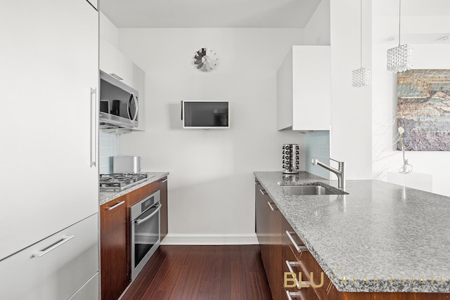 100 Riverside Blvd Unit 7-H, New York City, NY 10069 - kitchen with appliances with stainless steel finishes, a sink, baseboards, modern cabinets, and light stone counters