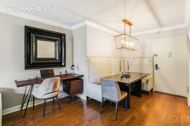 dining space featuring wood finished floors, baseboards, a chandelier, and ornamental molding