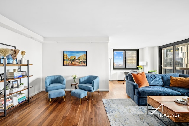 living room with baseboards and wood finished floors