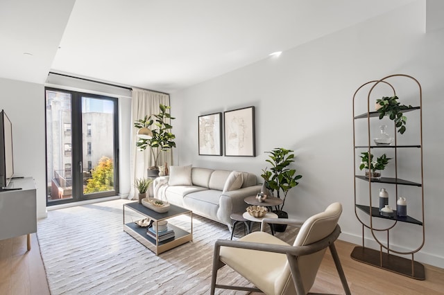500 W 45th St Unit 207, New York City, NY 10036 - living room featuring light wood-style floors and baseboards