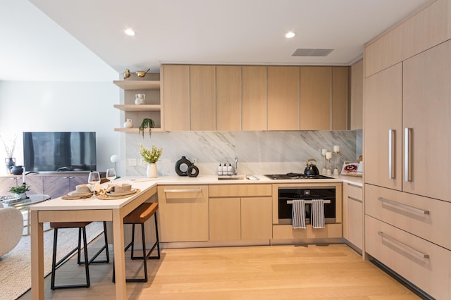 kitchen with oven, light brown cabinets, light countertops, open shelves, and recessed lighting