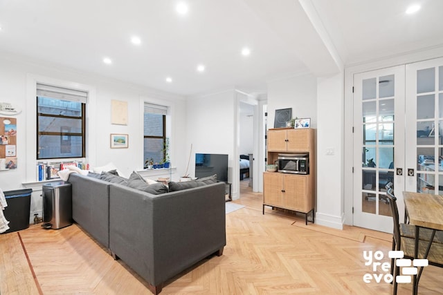 living area featuring baseboards, french doors, ornamental molding, and recessed lighting