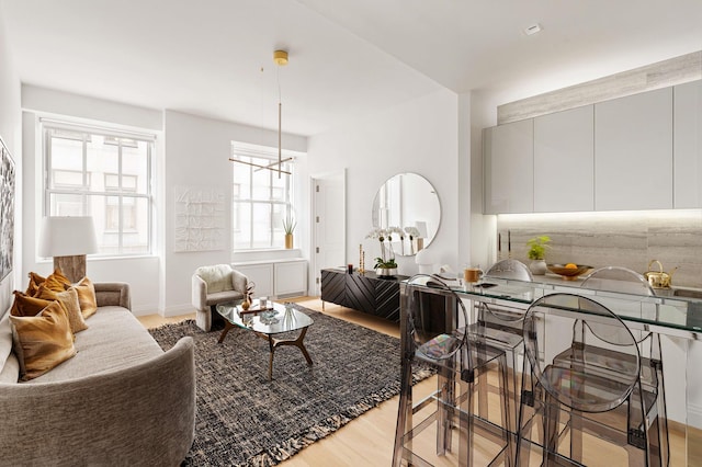 living area featuring an inviting chandelier and light wood-style floors