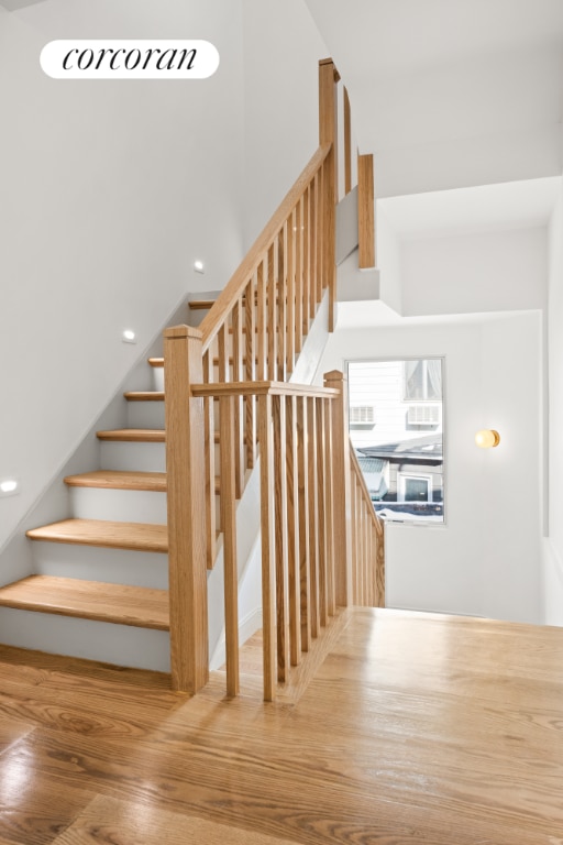 stairway with hardwood / wood-style flooring