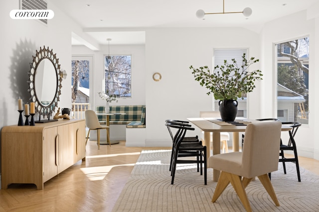 dining space featuring light parquet flooring and a healthy amount of sunlight