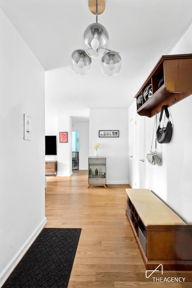 mudroom featuring light wood-style floors and baseboards