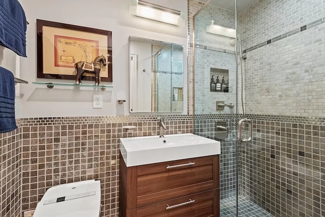 66 Madison Ave Unit 1A, New York City, NY 10016 - bathroom featuring tile walls, vanity, a shower stall, toilet, and wainscoting