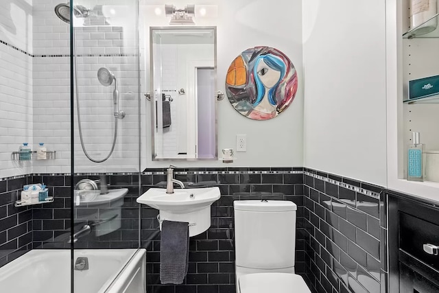 66 Madison Ave Unit 1A, New York City, NY 10016 - bathroom with tile walls, a wainscoted wall, toilet, and shower / bathtub combination