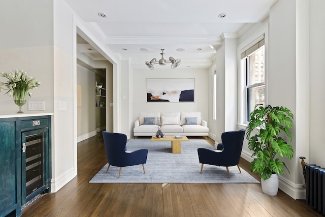 living area with wine cooler, baseboards, dark wood finished floors, and radiator heating unit