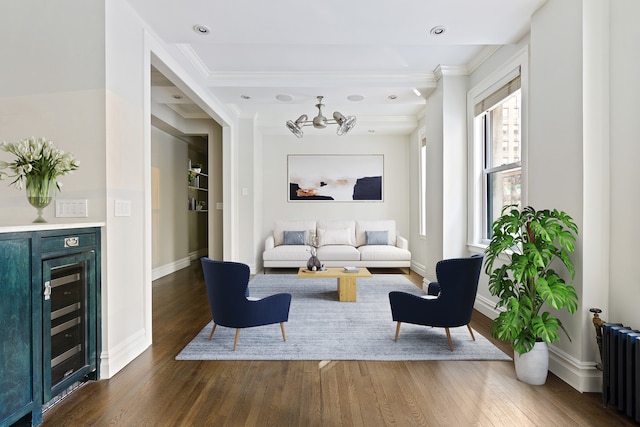 living room featuring beverage cooler, radiator heating unit, wood finished floors, and baseboards