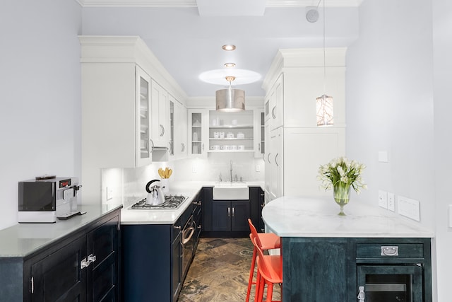 66 Madison Ave Unit 1A, New York City, NY 10016 - kitchen featuring a sink, stainless steel gas cooktop, glass insert cabinets, dark cabinetry, and white cabinets