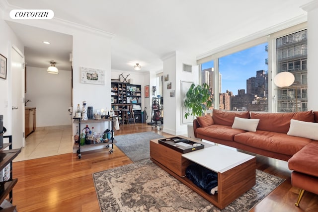 living room with ornamental molding and wood-type flooring