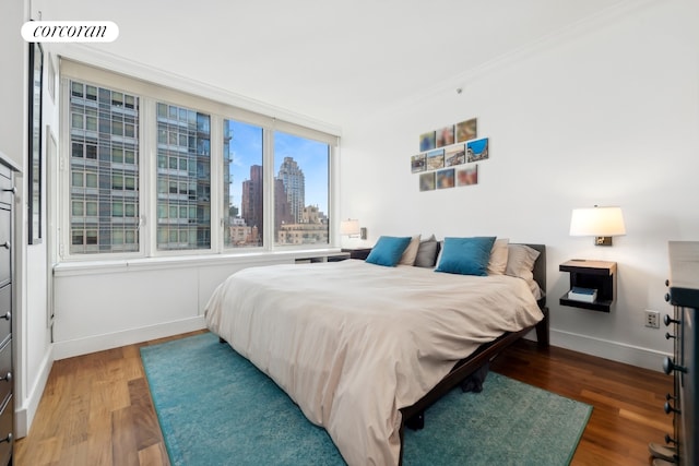 250 E 53rd St Unit 1403, New York City, NY 10022 - bedroom with a view of skyline and wood finished floors