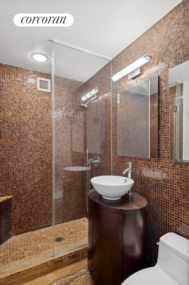 250 E 53rd St Unit 1403, New York City, NY 10022 - full bath with tile walls, a shower stall, and vanity