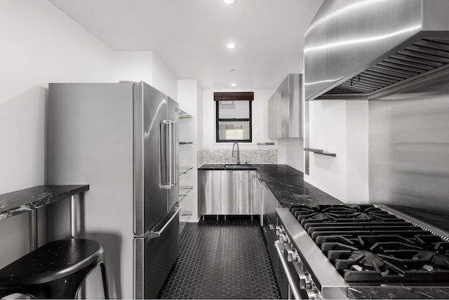 kitchen with high quality appliances, dark stone counters, recessed lighting, wall chimney exhaust hood, and modern cabinets