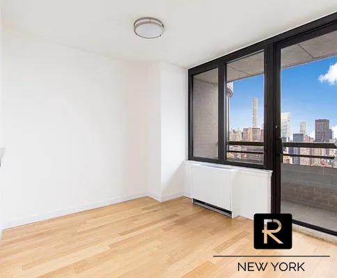 empty room with baseboards, a city view, and wood finished floors