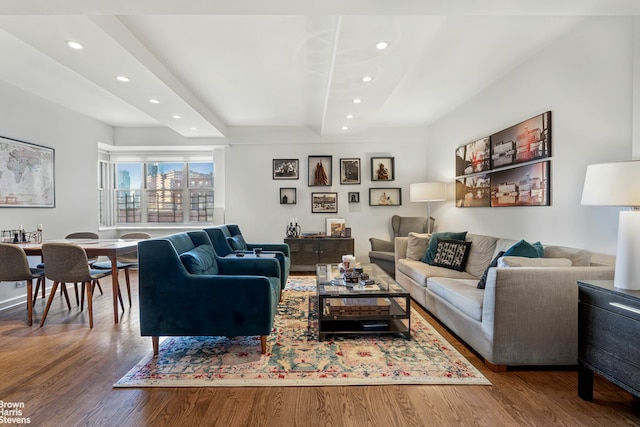 living area featuring recessed lighting, beam ceiling, and wood finished floors