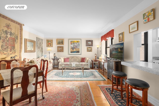 living area with visible vents and crown molding