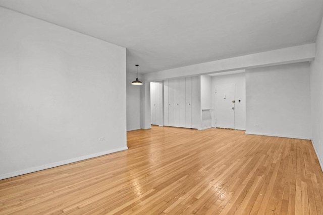 empty room with light hardwood / wood-style flooring