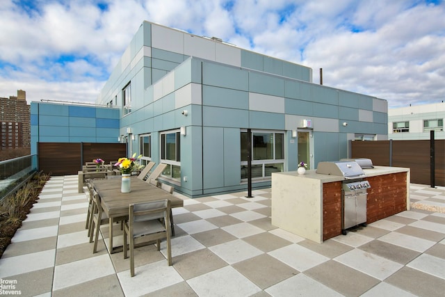 view of patio / terrace with a grill, an outdoor kitchen, and outdoor dining space