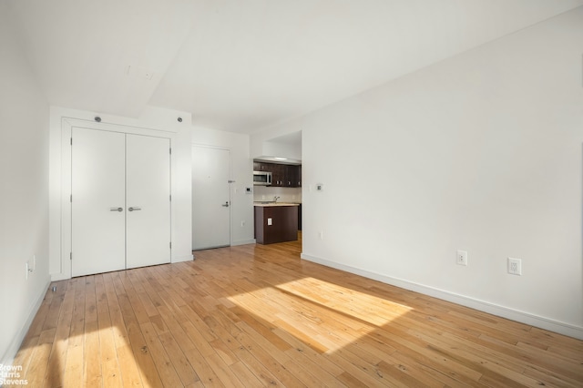 interior space with light wood-type flooring and baseboards