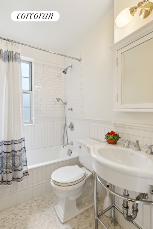 bathroom featuring shower / tub combo, tile patterned floors, and toilet