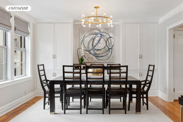 dining space with a notable chandelier and light wood-type flooring