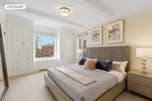 bedroom featuring light carpet and beam ceiling