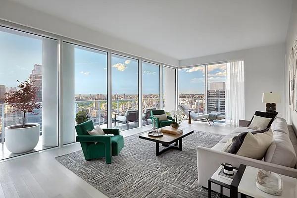 living area with a healthy amount of sunlight, a city view, and wood finished floors