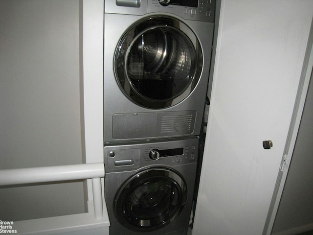 washroom with laundry area and stacked washer / dryer