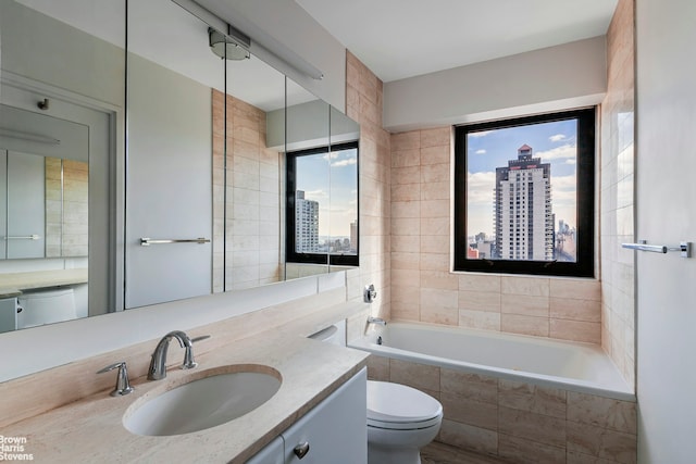 bathroom with a view of city, tiled bath, vanity, and toilet