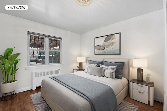 bedroom featuring baseboards, radiator heating unit, visible vents, and dark wood-type flooring