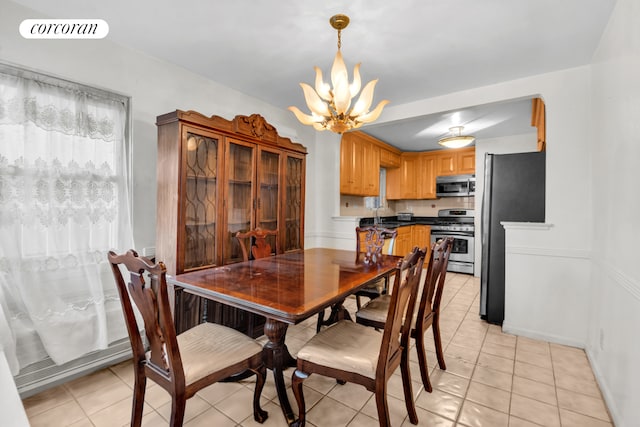 dining space with light tile patterned floors, visible vents, and an inviting chandelier