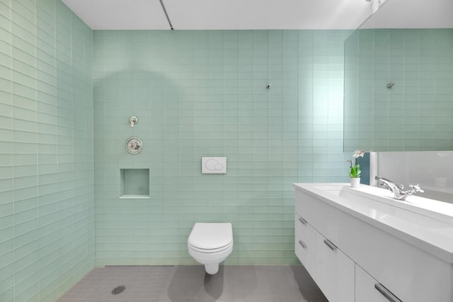 bathroom featuring tile patterned flooring, toilet, walk in shower, tile walls, and vanity